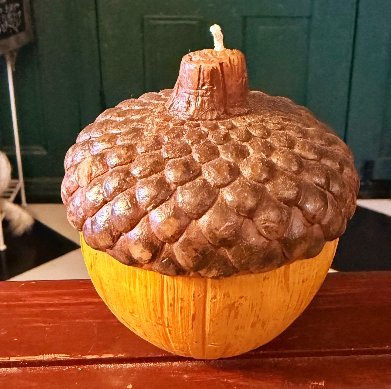 Novelty Acorn-shaped wax candle.